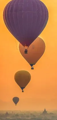 Looking for a stunning live wallpaper for your phone? Feast your eyes on this gorgeous creation depicting a group of hot air balloons, elegantly flying over a vibrant cityscape