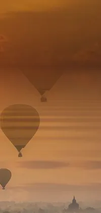 This phone live wallpaper portrays a mesmerizing image of hot air balloons flying over a city, which serves as an amazing backdrop for your device