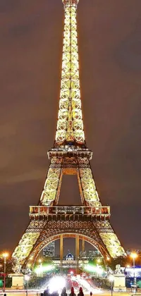 Enjoy the Parisian charm with a stunning Eiffel Tower night live wallpaper for your phone! Illuminated in bright lights, this digital rendering showcases every beautiful detail of the iconic landmark