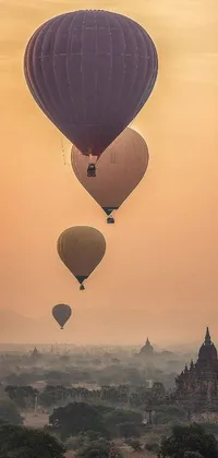 This phone live wallpaper features a group of hot air balloons floating in the sky against a beige mist backdrop