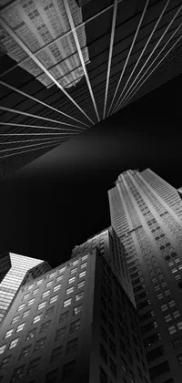 This phone live wallpaper showcases a striking black and white photograph of lofty buildings