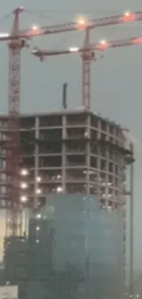 This phone live wallpaper showcases a stunning image of a tall building under construction, featuring a blurry screenshot-style footage, overlooking the structure from the ground upwards