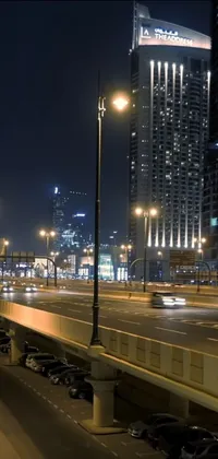 This phone live wallpaper showcases a bustling city street at night, featuring lots of traffic and beautiful lighting