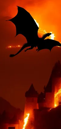 This phone live wallpaper showcases a breathtaking scene featuring a castle burning in a violent firestorm against a picturesque mountain backdrop