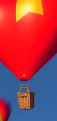 This phone live wallpaper features two hot air balloons designed in the shape of a heart using precisionism