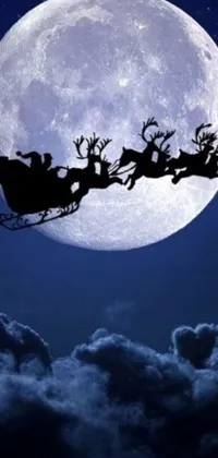 This stunning phone live wallpaper features Santa's sleigh soaring through the night sky against a breathtaking full moon backdrop