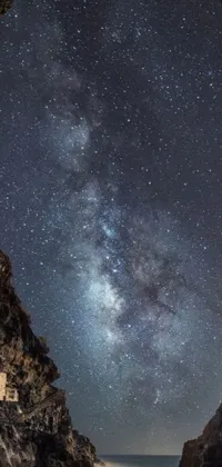This phone live wallpaper captures the night sky as seen from a mythical cave, with a Greek-inspired fantasy panorama