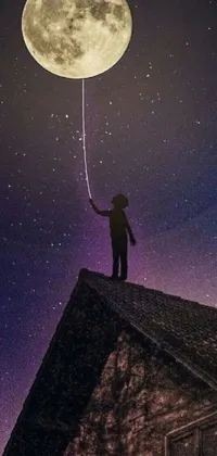 This live wallpaper features a magical scene with a person standing on a roof, holding a balloon and magic wand while looking at a star-chart