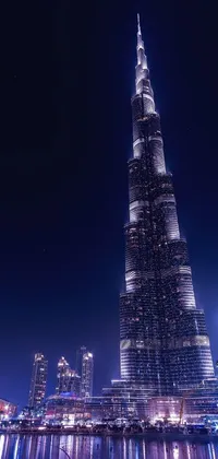 This live wallpaper showcases the Burj Khalifa tower towering over a city at night with a surrealistic touch