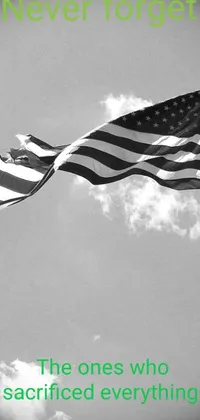 This live wallpaper showcases a captivating monochromatic photograph of an American flag blowing in the wind