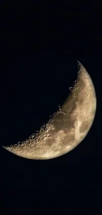 This <a href="/">phone live wallpaper</a> features a mesmerizing half moon set against a dark night sky