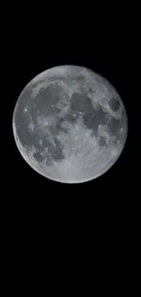 This stunning live wallpaper captures the beauty of a full moon against a dark, moody sky
