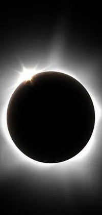 This phone live wallpaper features an eclipse set against a dark sky
