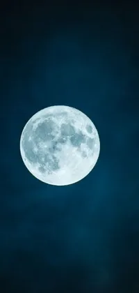 This phone live wallpaper displays a stunning blue background with a circular white full moon shining brightly, set against a dark sky