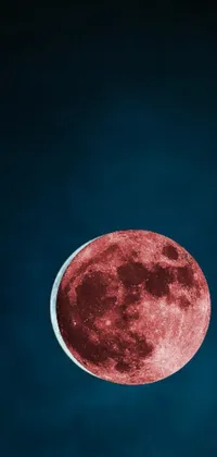 This phone live wallpaper features a surrealistic full moon over a blue sky background with captivating geometric patterns