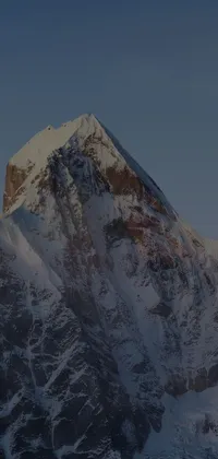 This stunning live wallpaper features a snow-capped mountain under a blue sky, with the Jaya Su Bergling mountain range in the background
