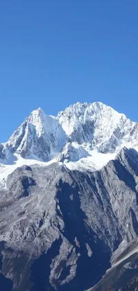 This stunning live wallpaper displays a gorgeous snow-capped mountain on a sunny day