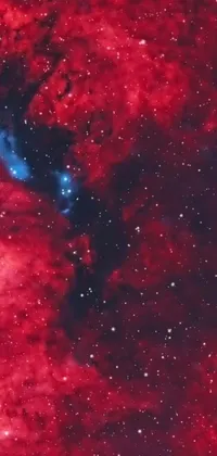 This stunning live wallpaper features a shifting and swirling red nebula with a vibrant blue star at the center, set against a cosmic field of stars and galaxies