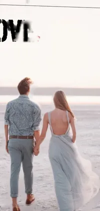 This stunning live wallpaper depicts a romantic couple walking hand in hand on a picturesque beach