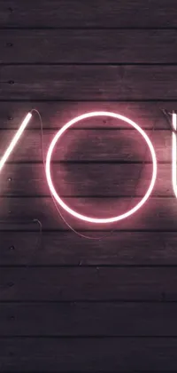 This live phone wallpaper boasts an eye-catching neon sign that reads "JOY" against a wooden wall