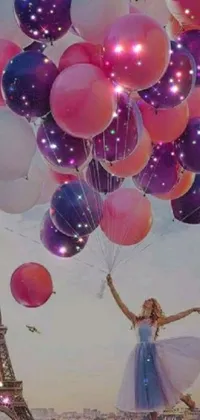 This phone live wallpaper displays a colorized photo featuring a woman holding a bunch of party balloons in front of the Eiffel Tower