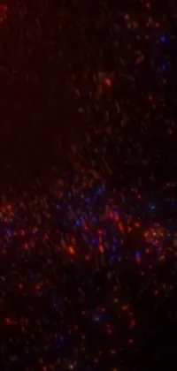 This live wallpaper for your phone showcases a mesmerizing black hole surrounded by swirling red and blue stars