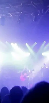 This picturesque live wallpaper depicts a vibrant group performing on stage accompanied by guitars and stunning lights