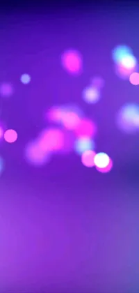 This phone live wallpaper is a beautiful abstract design that showcases a blurry photo of a purple and blue background