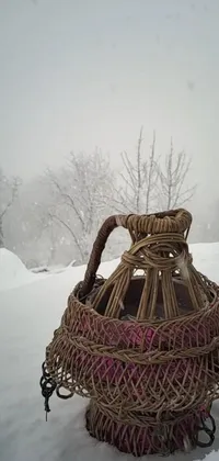 This live wallpaper features a wicker basket on snow covered ground, with a Persian folklore inspired picture adding a cultural touch