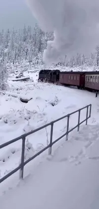 This phone live wallpaper depicts a train journey through a snow-covered forest in vibrant colors