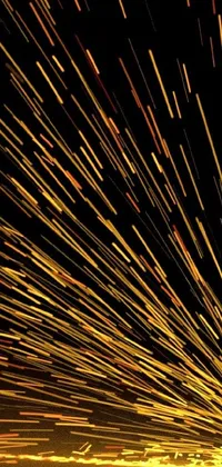 This phone live wallpaper features a close-up of a firework on a black background, showcasing a microscopic photo with geometric lines in the sky and orange street lights