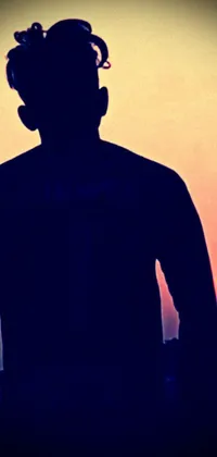 This phone live wallpaper showcases a beautiful silhouette in front of a mesmerizing sunset