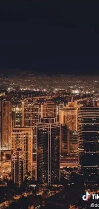 Enhance the look of your phone with an electrifying live wallpaper! This digital artwork showcases a breathtaking aerial view of a modern city at night with a stunning skyline and desert landscape in the background