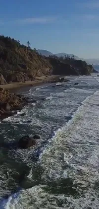 This breathtaking phone live wallpaper presents a stunning view of the Pacific Northwest coast, depicting a large body of water and a towering cliff