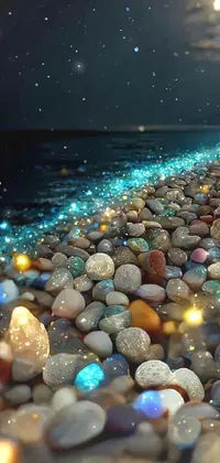 This live wallpaper depicts a stunning scene of rocks atop a beach surrounded by small, colorful stones