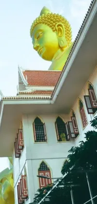 This phone live wallpaper brings a magnificent yellow Buddha statue to your screen, set against a stunning white building and surrounded by gold and green hues