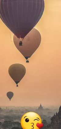 This live wallpaper depicts a group of hot air balloons soaring over a mystical cityscape