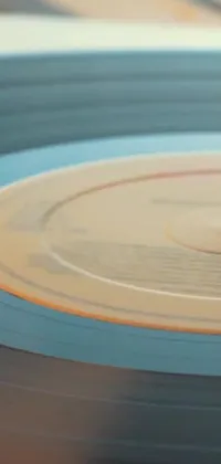 This live wallpaper features a close-up of a vinyl record on a table, with a photorealistic soft vinyl texture