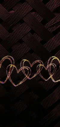 This phone live wallpaper features heart-shaped lights dancing in warm tones of gold, set against an amoled background