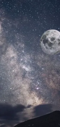This live wallpaper depicts a stunning night sky filled with twinkling stars and a glowing full moon