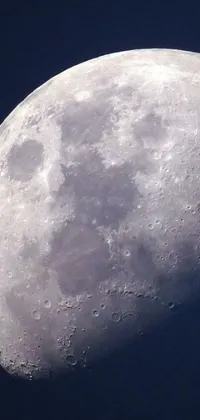This phone live wallpaper features a stunning close-up image of a moon in the sky with visible craters on the surface