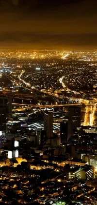Indulge in the magnificence of the stunning aerial view of a city at night depicted in this phone live wallpaper