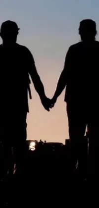 Looking for the perfect live wallpaper for your phone that supports the LGBTQ+ community? Look no further than this delightful couple holding hands in silhouette! This image is perfect for pride month and the background can be customized in a wide range of colors