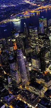 This live wallpaper features an aerial view of a modern, glowing downtown city at night