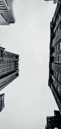 This phone live wallpaper features a captivating black and white photo of tall skyscrapers in a gothic Gotham City background