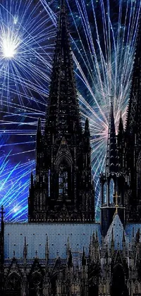 This phone live wallpaper depicts an awe-inspiring sight of fireworks exploding against a cathedral's majestic architecture at night