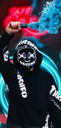 This phone live wallpaper is an eye-catching cyberpunk design with a man wearing a black hoodie and white mask