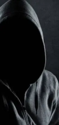 Looking for a unique and mesmerizing live wallpaper for your phone? Check out this black and white design featuring a mysterious figure in a hoodie and black mask, lurking in the dark