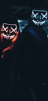 This live wallpaper for your phone features a captivating cyberpunk-style artwork of a man and a woman wearing mysterious smiling masks standing next to each other in the dark