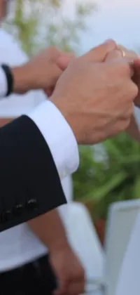 This stunning phone live wallpaper showcases a touching moment of a couple's wedding ceremony